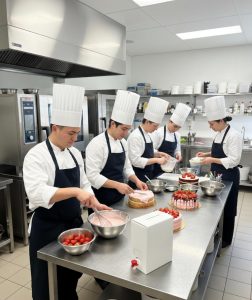 Pastry chefs using Baor´s strawberry purée with sugar to prepare cakes in a professional bakery kitchen